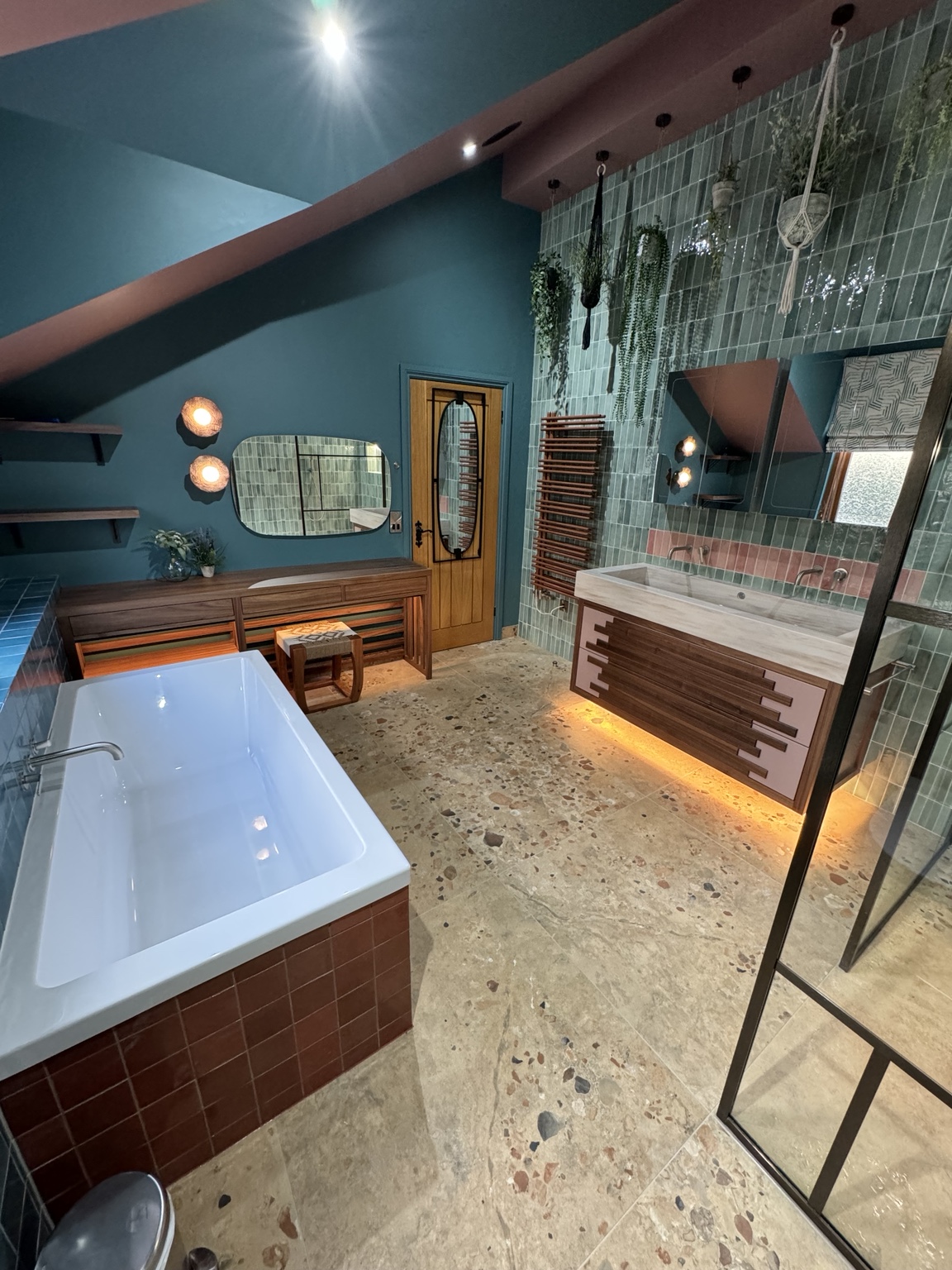 Bathroom with bath, bespoke vanity and green feature tiling