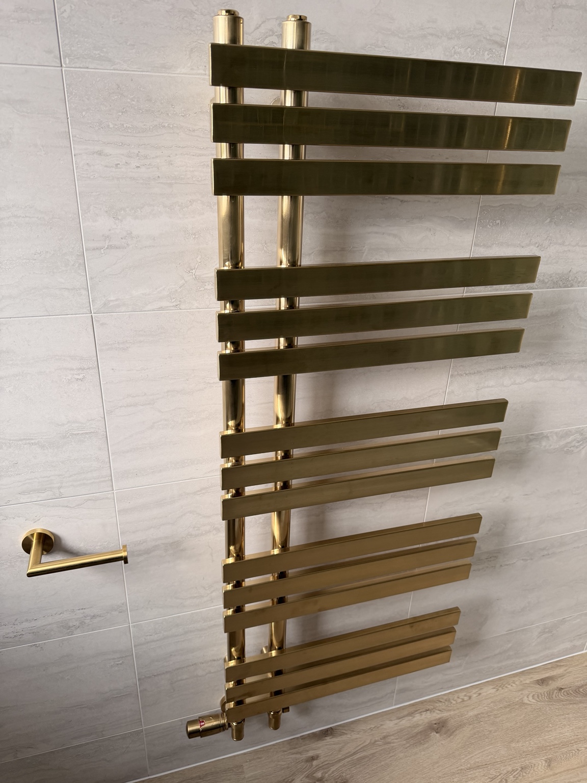 Gold-finish designer towel rail installed by SMC