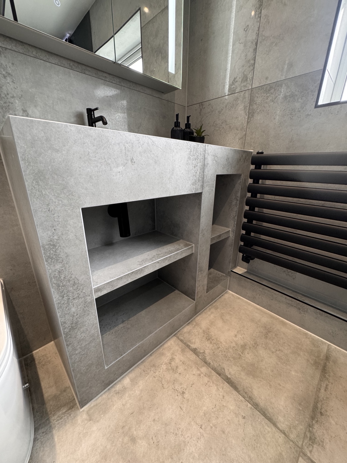 Open storage beneath the tiled basin